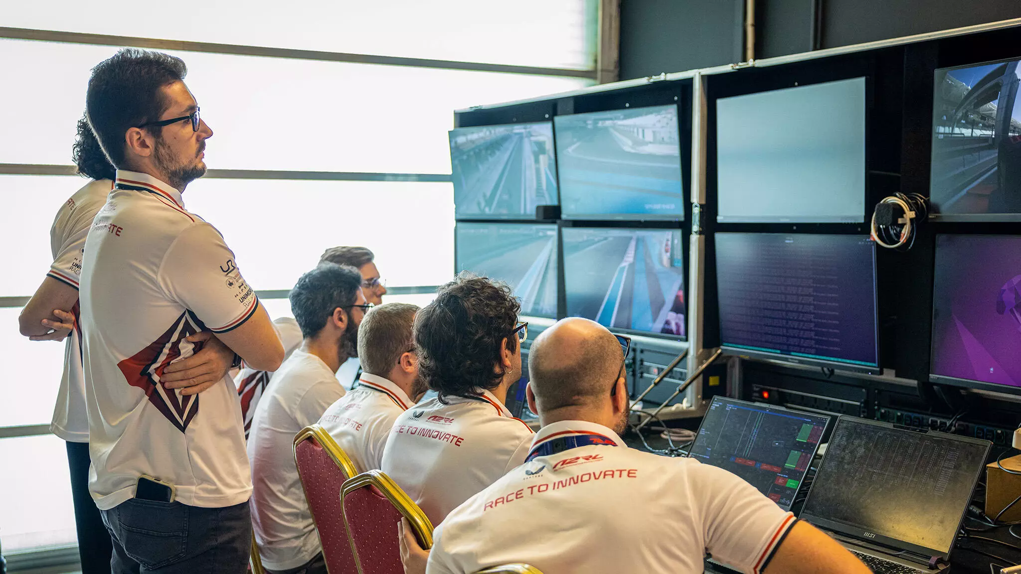 Teams are constantly monitoring their AI-powered car but on a race day, theyre just spectators — Shot by Spacesuit Media & A2RL Teams are constantly monitoring their AI-powered car but on a race day, theyre just spectators — Shot by Spacesuit Media & A2RL