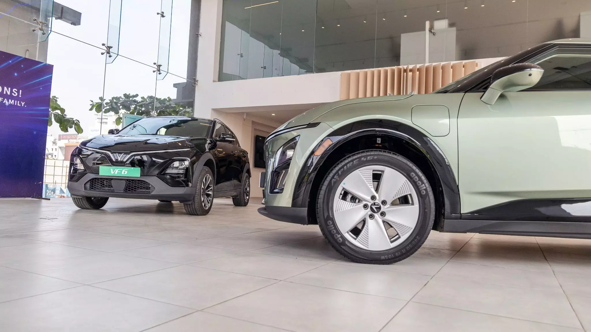(L) Jet Black VF 6 Wind Infinity (top-spec) variant and (R) Urban Mint VF 7 Earth variant displayed in the foyer area — Shot by Sachin Khot for India