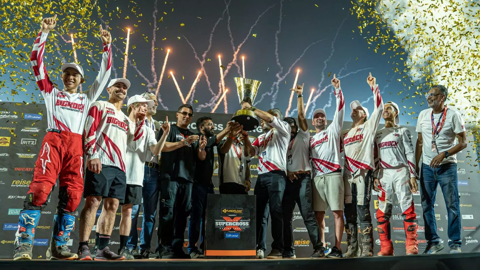 ISRL Brand Ambassador presents the championship trophy to Team BigRock Motorsports SX amidst celebratory festivities