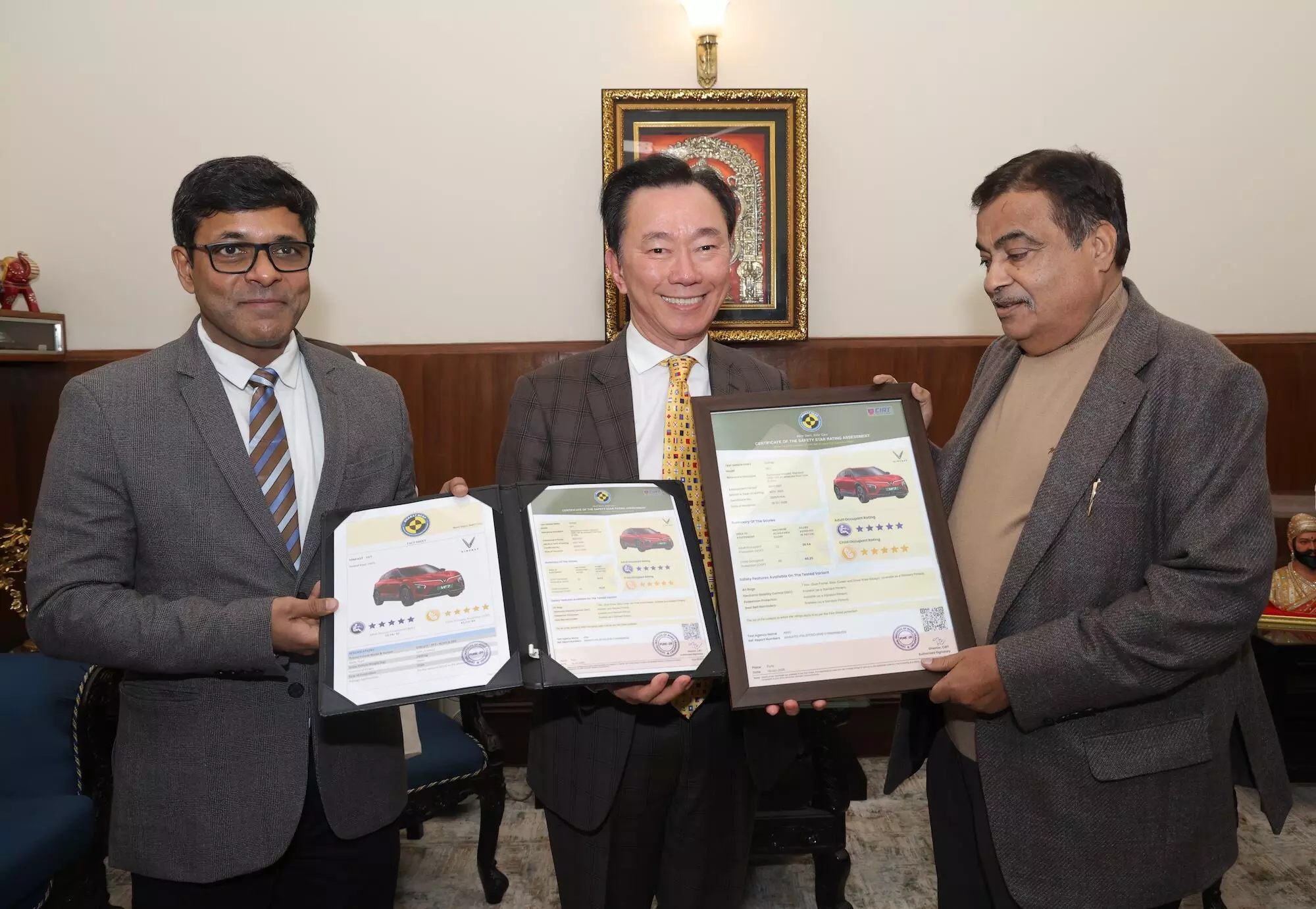 Pham Sanh Chau (centre), CEO of VinFast Asia, and Tapan Ghosh (left) CEO of VinFast India receives the Bharat NCAP safety certification for the VF 6 from Nitin Gadkari, Minister of Road Transport and Highways (right)